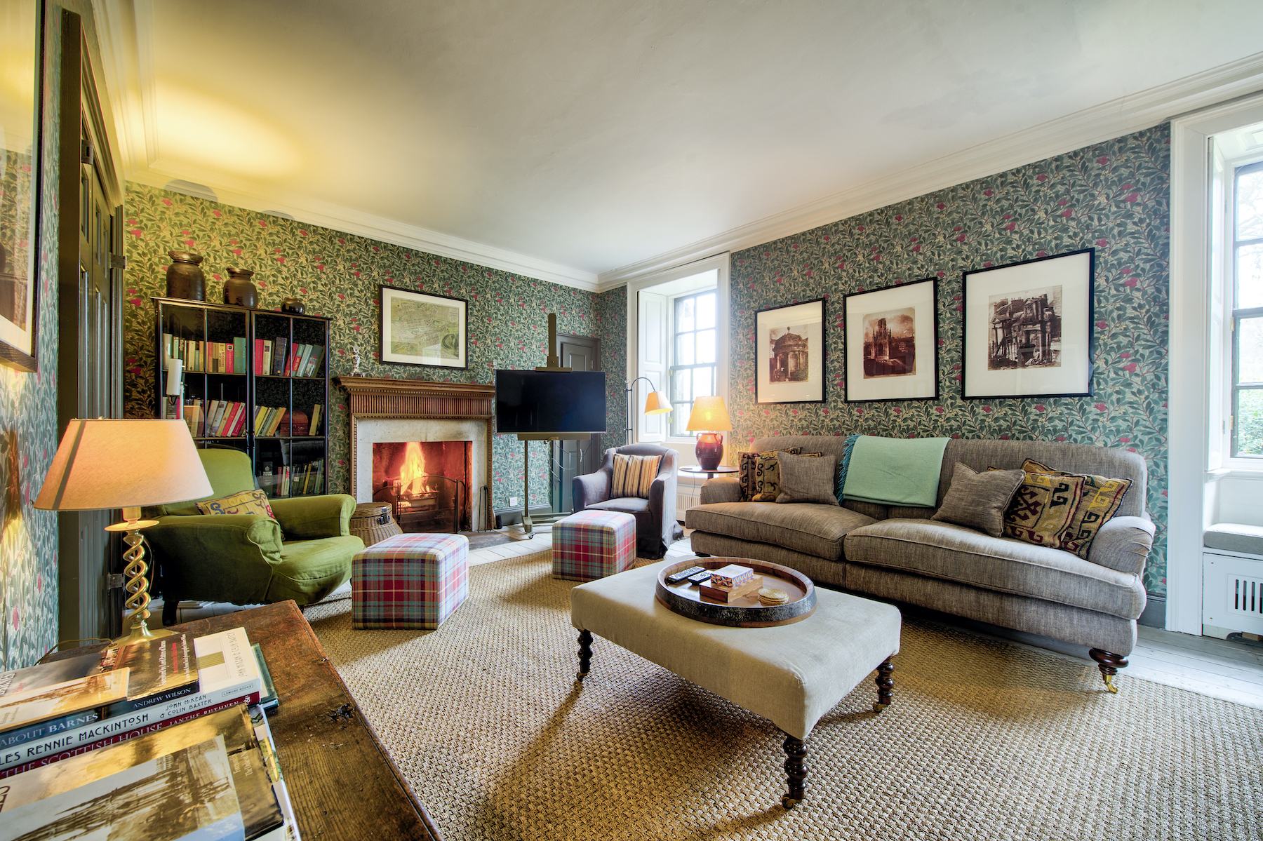 The living room at Rock House with period details and an open fire