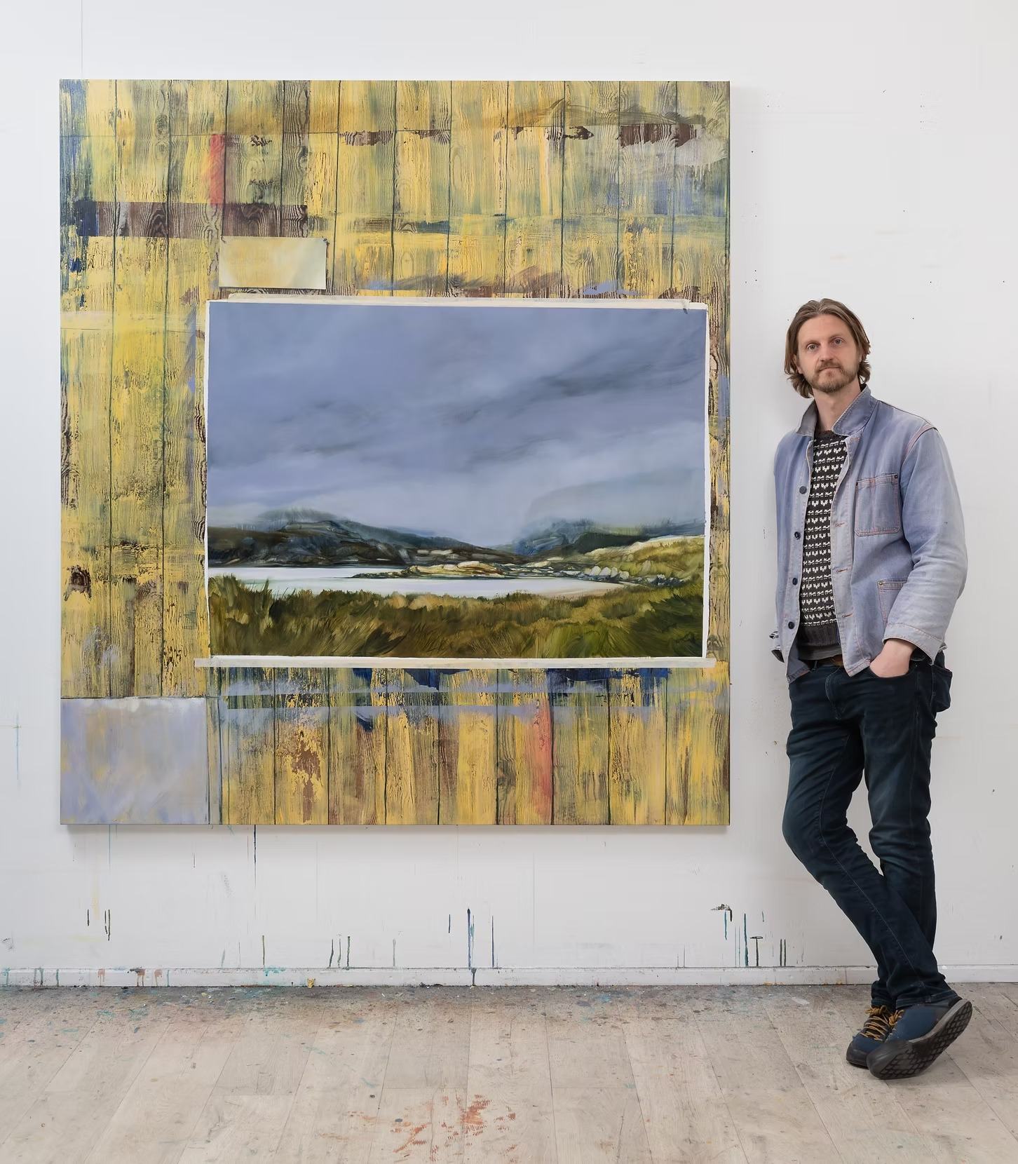 Painter Alastair Gordon in his studio beside his work, who undertook the first Rock House artist residency in 2017