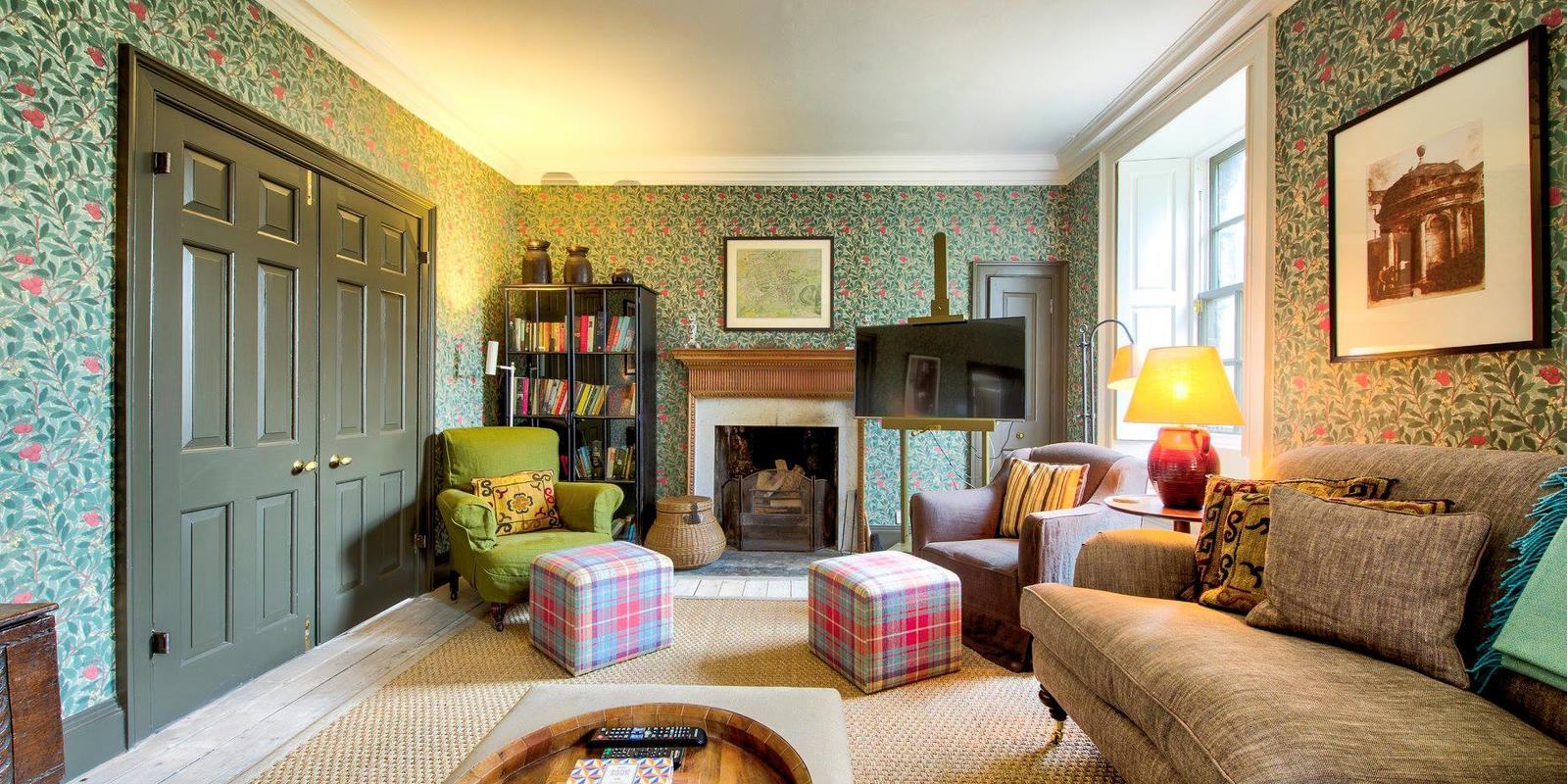 A warmly furnished living space at Rock House, Edinburgh, with period interiors